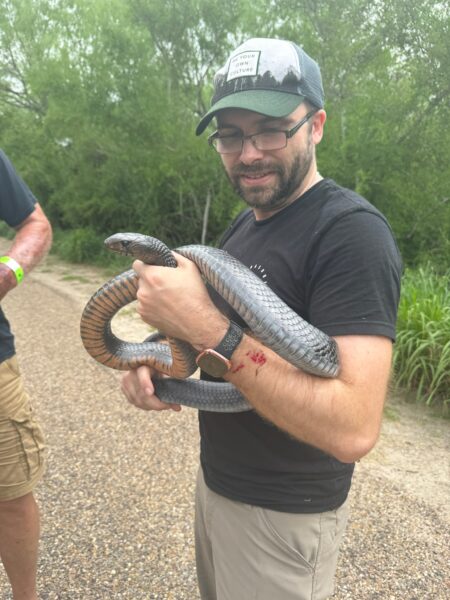 John holding a big snake.